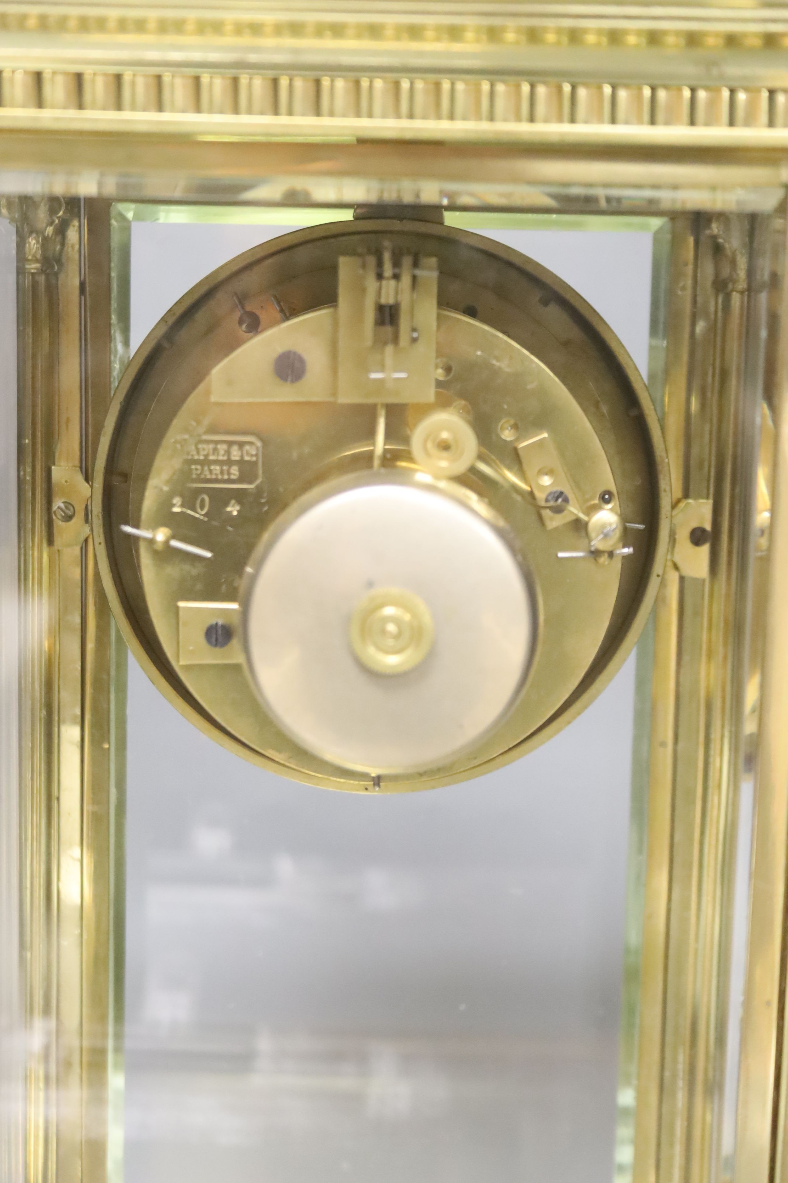 A 19th century French four-glass mantel clock with key and mercury filled pendulum bob 34cm